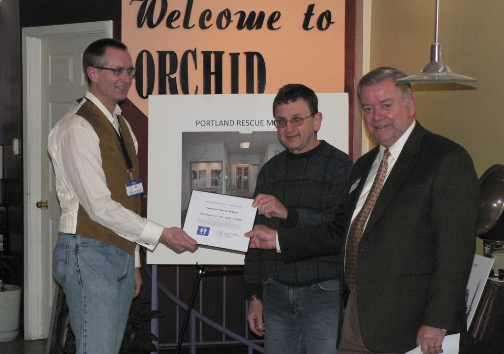 Portland Rescue Mission's JR Baker & Tom Lister accept PHLUSH Restroom of the Year Award from Mayor Potter